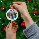 Personalized GR 20 ornament with custom hiking photo and year, held in hands in front of decorated Christmas tree.