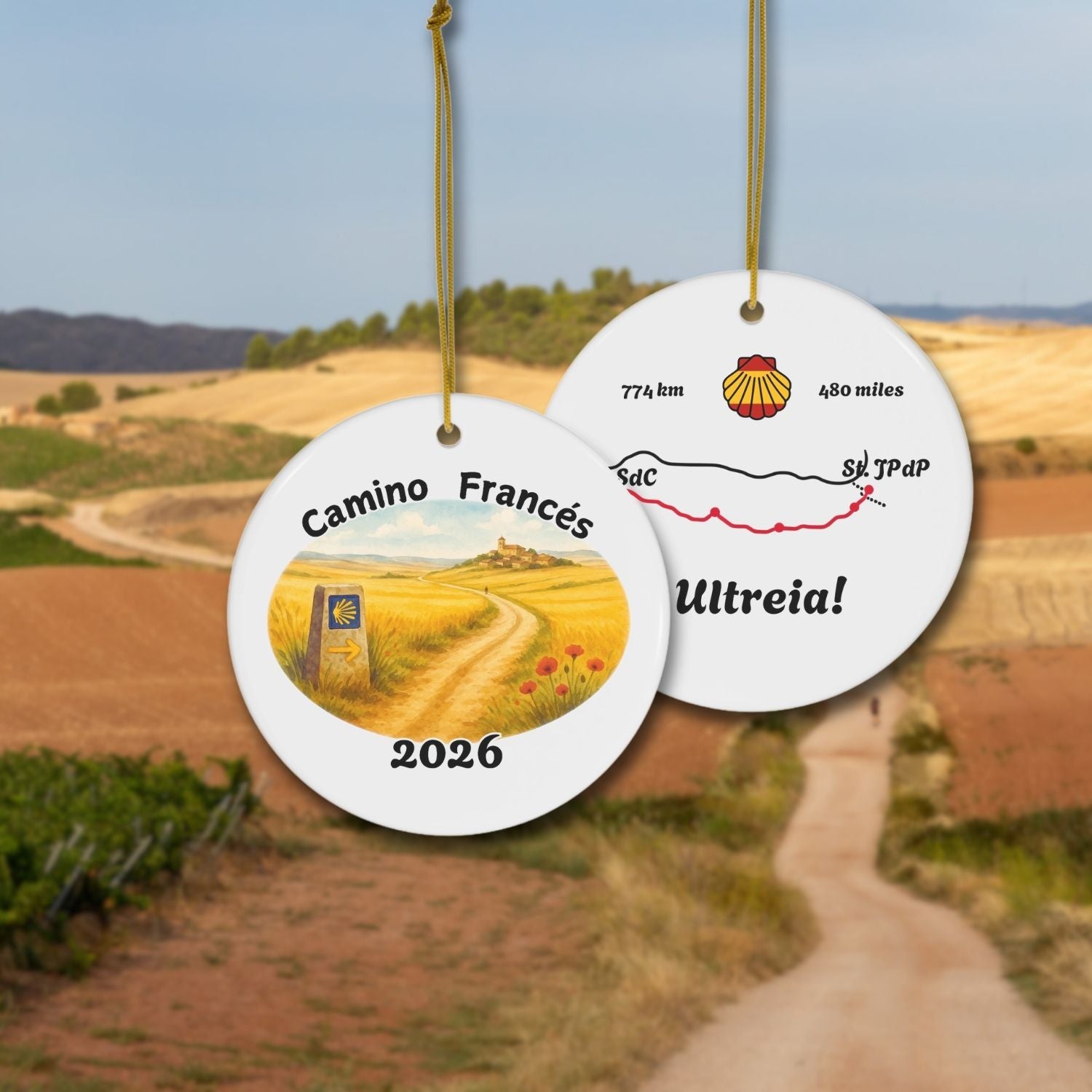 Camino Frances ceramic Ornament shown front and back in front of Meseta landscape.