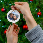 Personalized GR 20 ornament with custom hiking photo and year, held in hands in front of decorated Christmas tree.