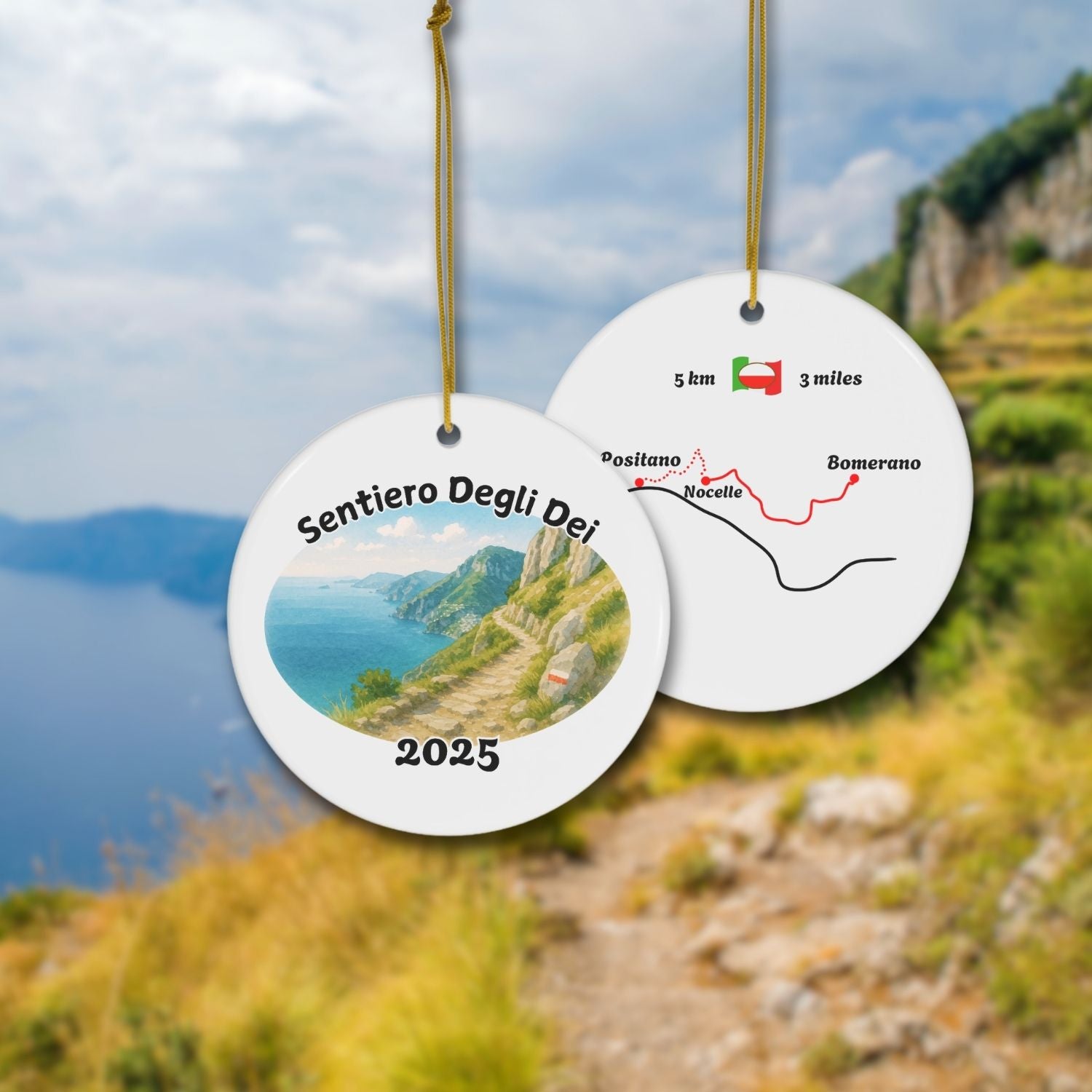 Front and back view of the Sentiero degli Dei ceramic ornament, featuring the coastal Path of the Gods watercolor design and gold cord hanger.