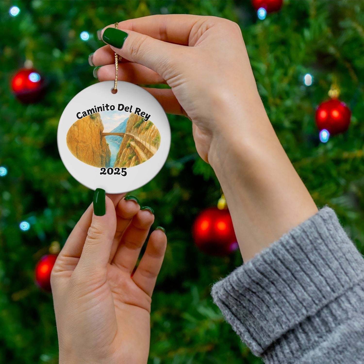 Caminito del Rey ornament shown in front of a Christmas tree, a unique keepsake for hikers who’ve walked the Spanish trail or dream of doing it one day.